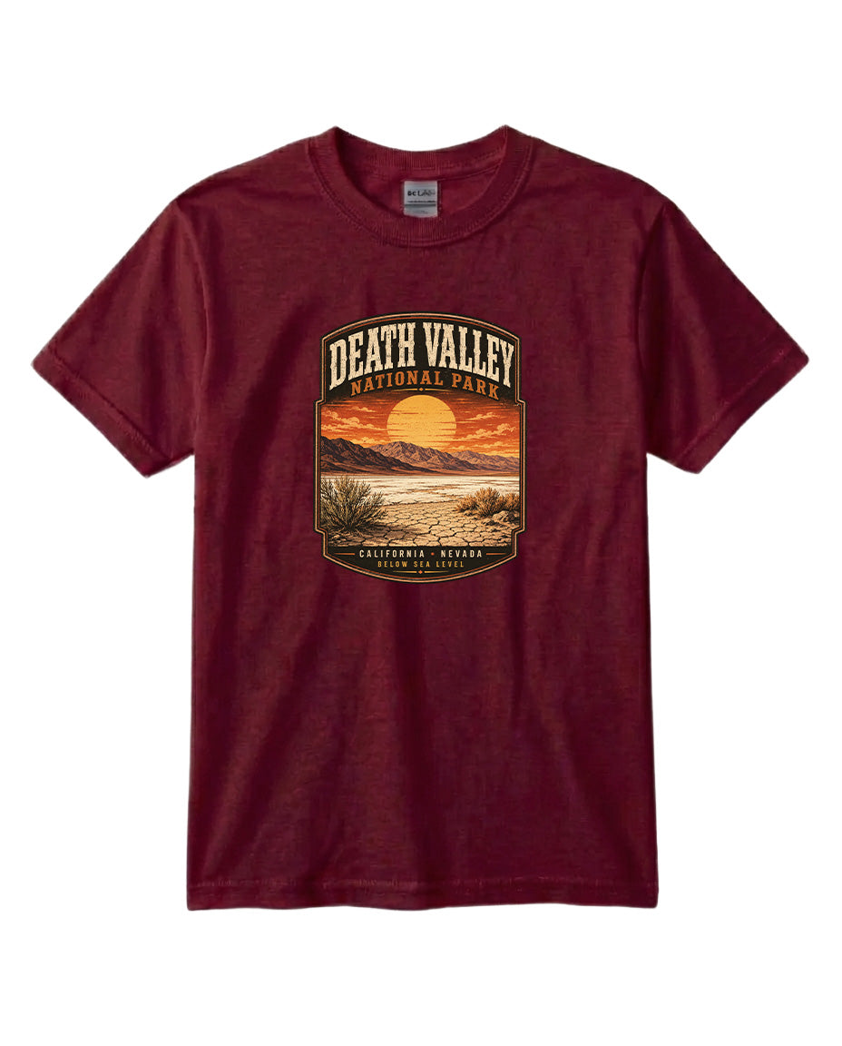 A burgundy-colored t-shirt with a graphic design depicting a sunset over Death Valley National Park, California, Nevada.