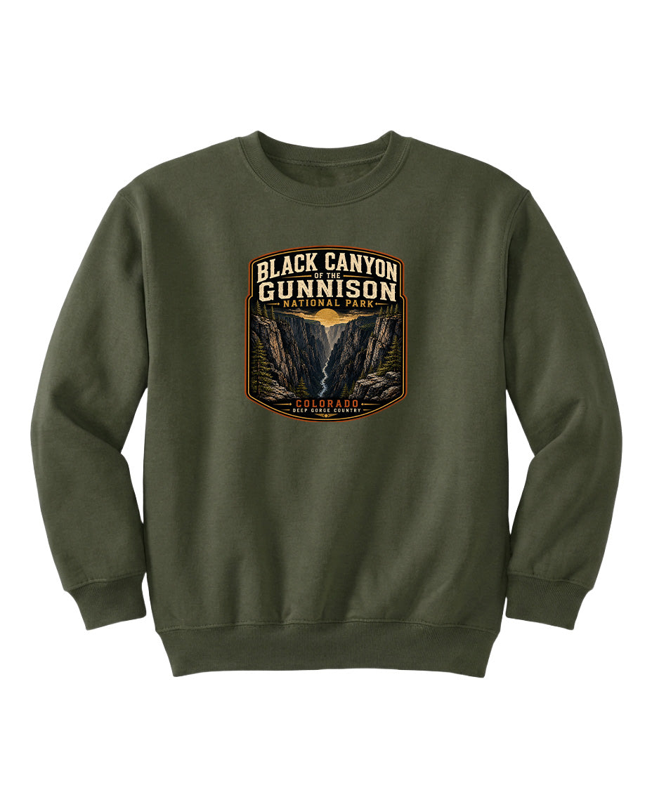 A green sweatshirt with a graphic design featuring the text "Black Canyon Gunnison National Park" and an illustration of a canyon.
