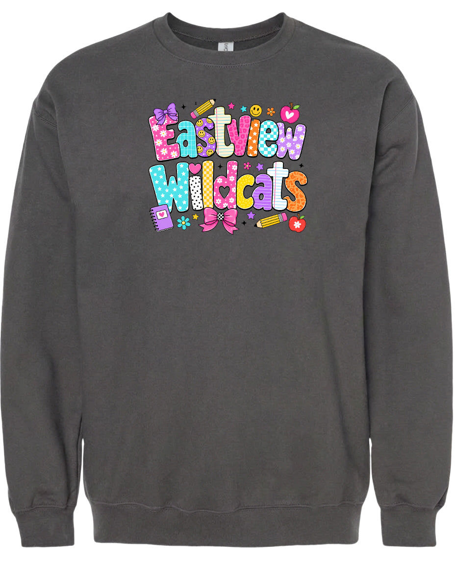A gray sweatshirt with a colorful graphic design featuring the text "Eastview Wildcats" and various decorative elements such as hearts, pencils, and flowers.