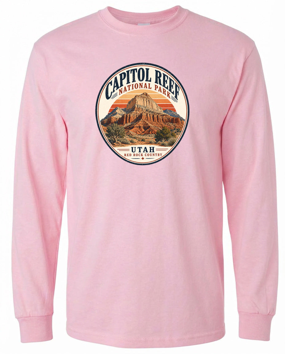 A pink long-sleeved t-shirt with a circular graphic design featuring the Capitol Reef National Park in Utah.
