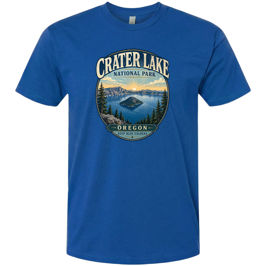 A blue t-shirt with a graphic design depicting Crater Lake National Park in Oregon, featuring a scenic landscape with a lake, mountains, and pine trees.