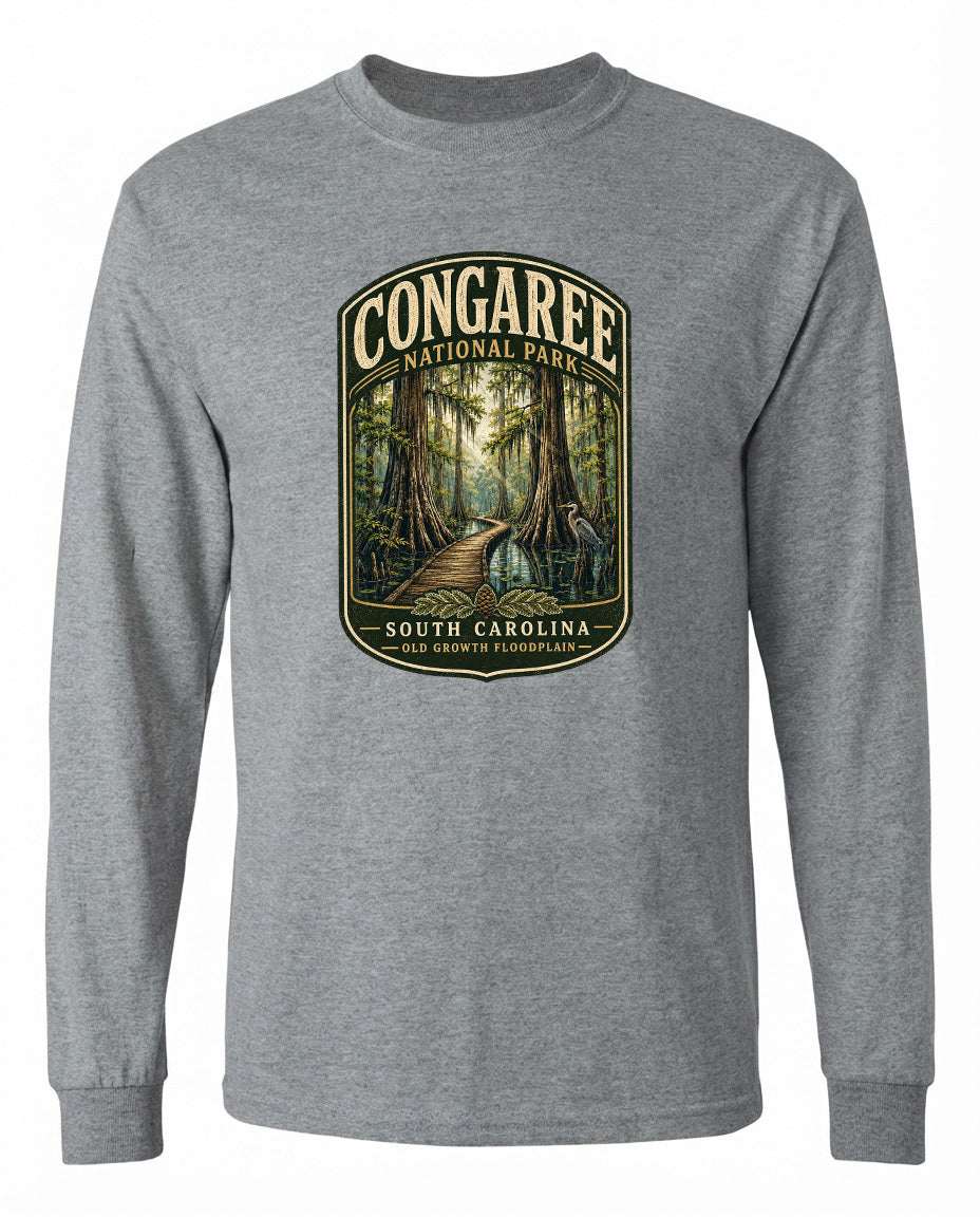 A gray long-sleeved t-shirt with a graphic design depicting a forest path leading through Congaree National Park in South Carolina.