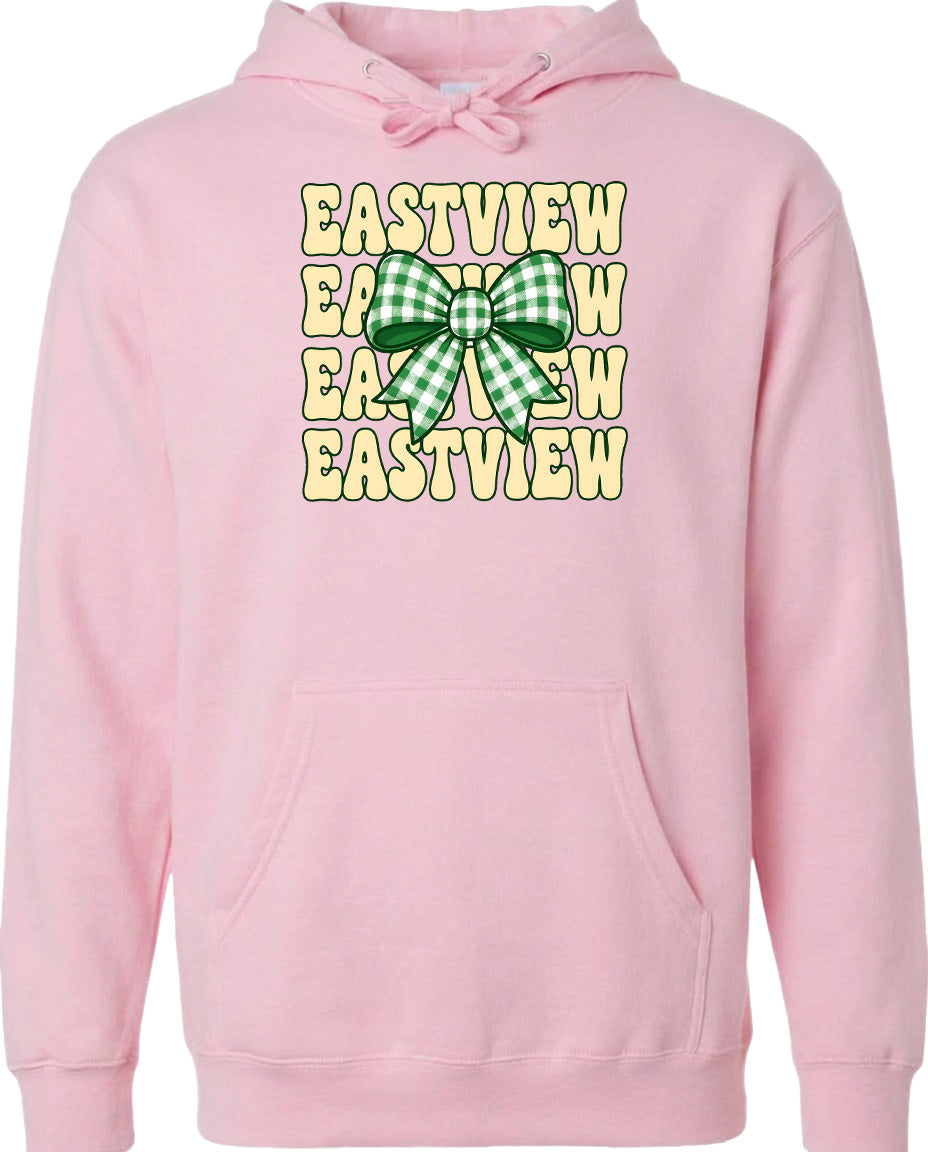 A pink hoodie with a graphic design featuring a green and white checkered bow and the text "EASTVIEW" repeated in a vertical pattern.