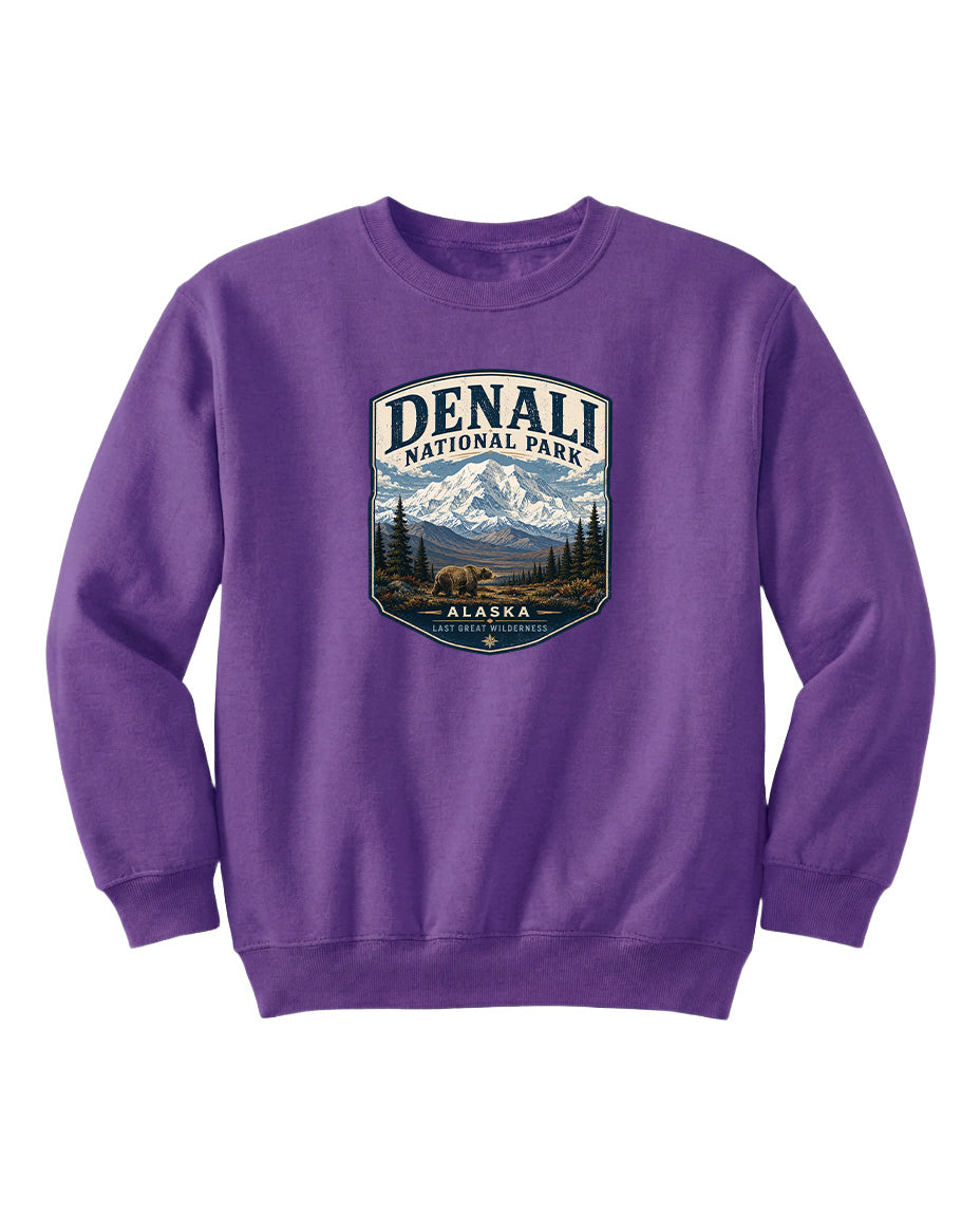 A purple sweatshirt with a graphic design featuring a mountain landscape and bears, representing Denali National Park in Alaska.