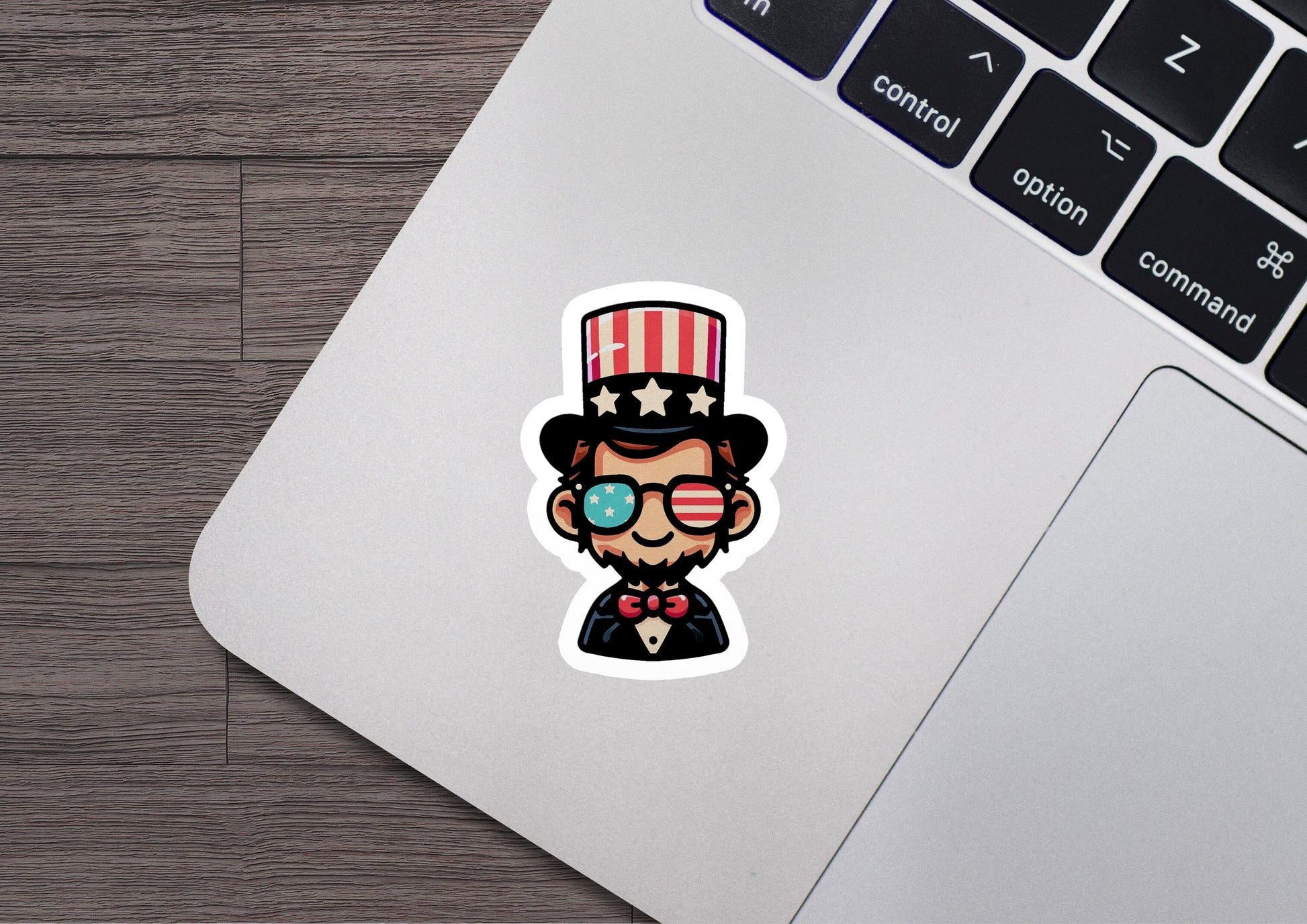 a laptop with a sticker of a man wearing a top hat