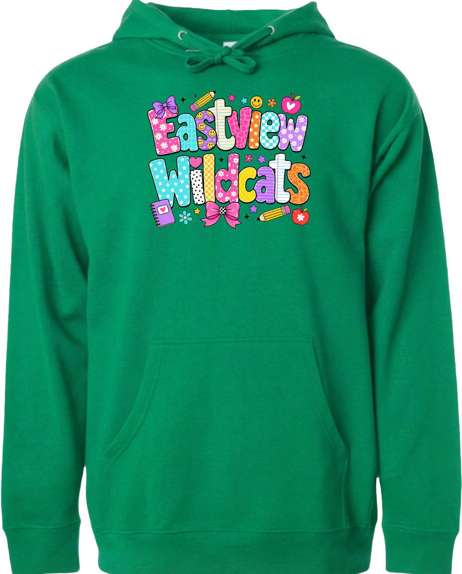 A bright green hoodie with a colorful graphic design featuring the text "Eastview Wildcats" and various school supplies such as pencils, scissors, and a heart.