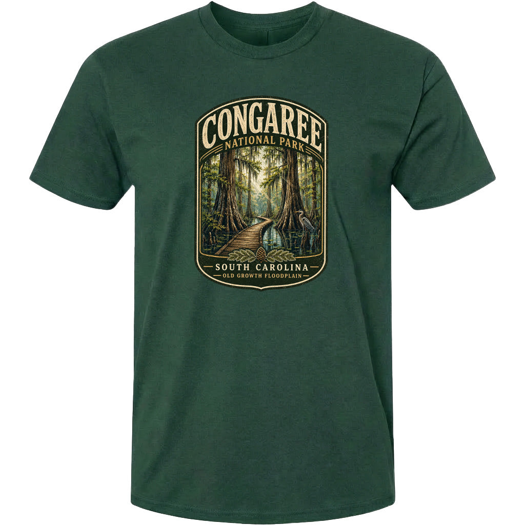A green t-shirt with a graphic design depicting a forest scene with a path leading through it, surrounded by trees and foliage.