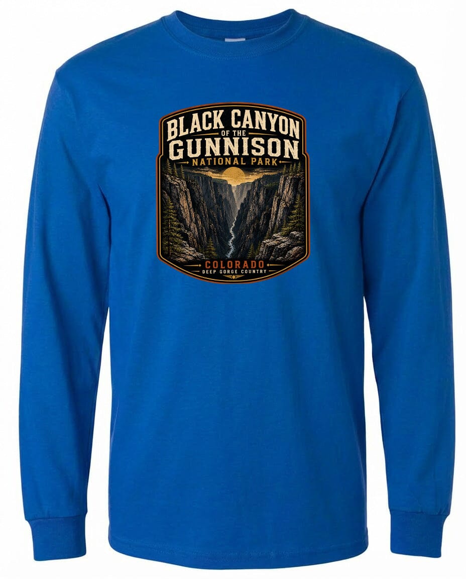 A blue long-sleeved t-shirt with a graphic design depicting the Black Canyon of the Gunnison National Park in Colorado.