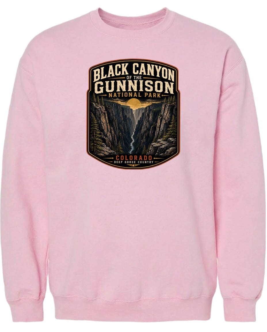 A pink sweatshirt with a graphic design depicting the Black Canyon of the Gunnison National Park in Colorado.