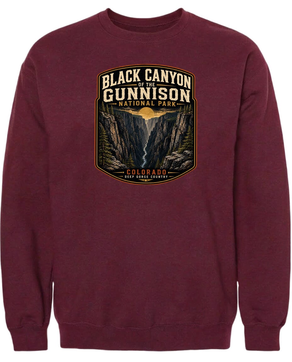 A burgundy-colored sweatshirt with a graphic design depicting the Black Canyon of the Gunnison National Park in Colorado.