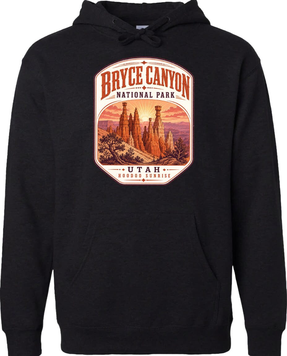 A black hoodie with a graphic design depicting the Bryce Canyon National Park in Utah, featuring the iconic hoodoos and the sunrise.
