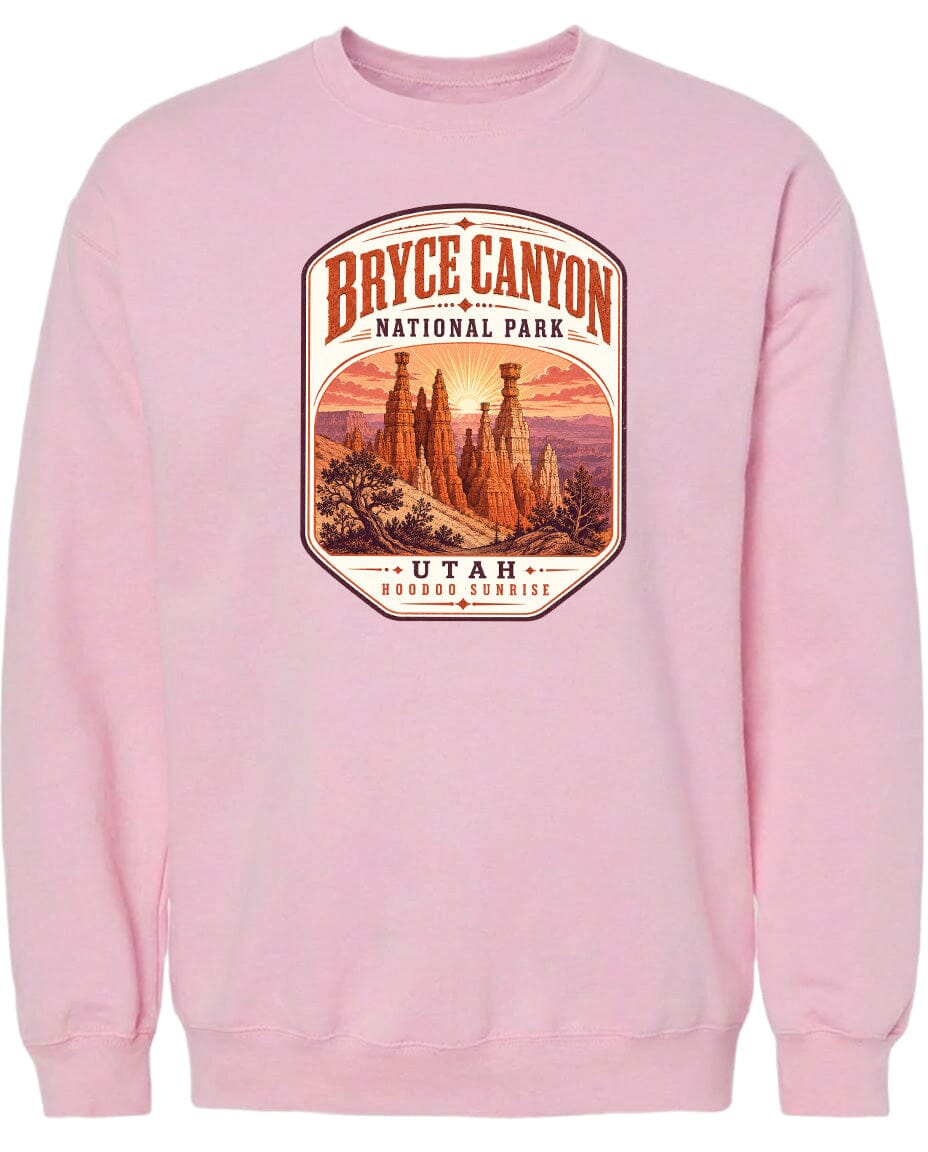 A pink sweatshirt with a graphic design depicting the Bryce Canyon National Park in Utah.