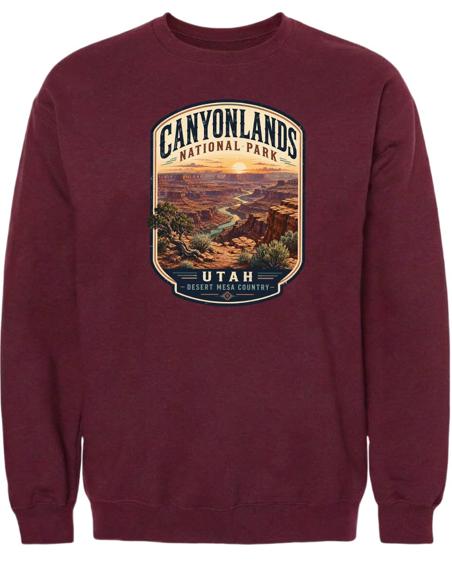 A burgundy-colored sweatshirt with a graphic design depicting the scenic landscape of Canyonlands National Park in Utah.