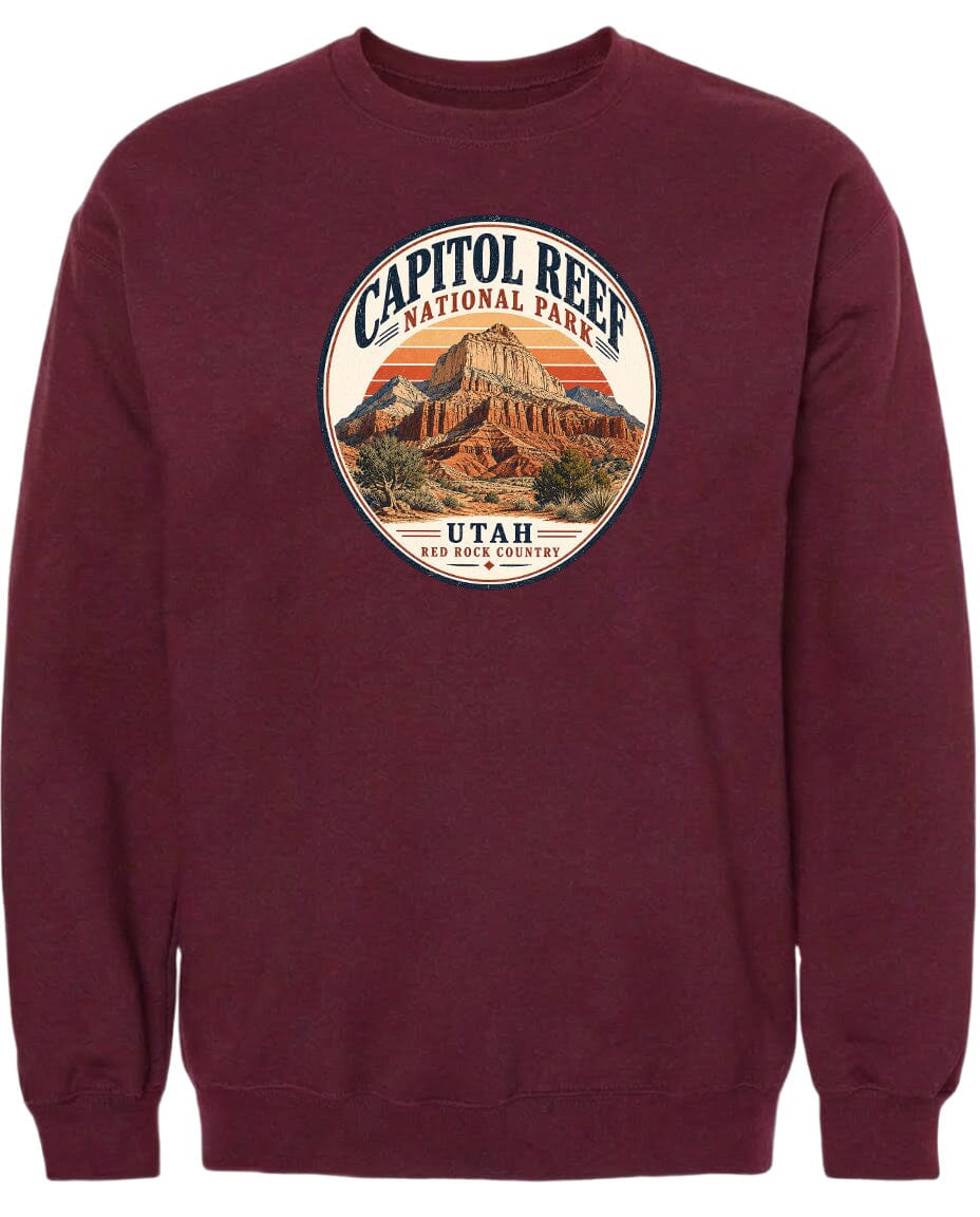 A burgundy-colored sweatshirt with a circular graphic design featuring the Capitol Reef National Park in Utah.