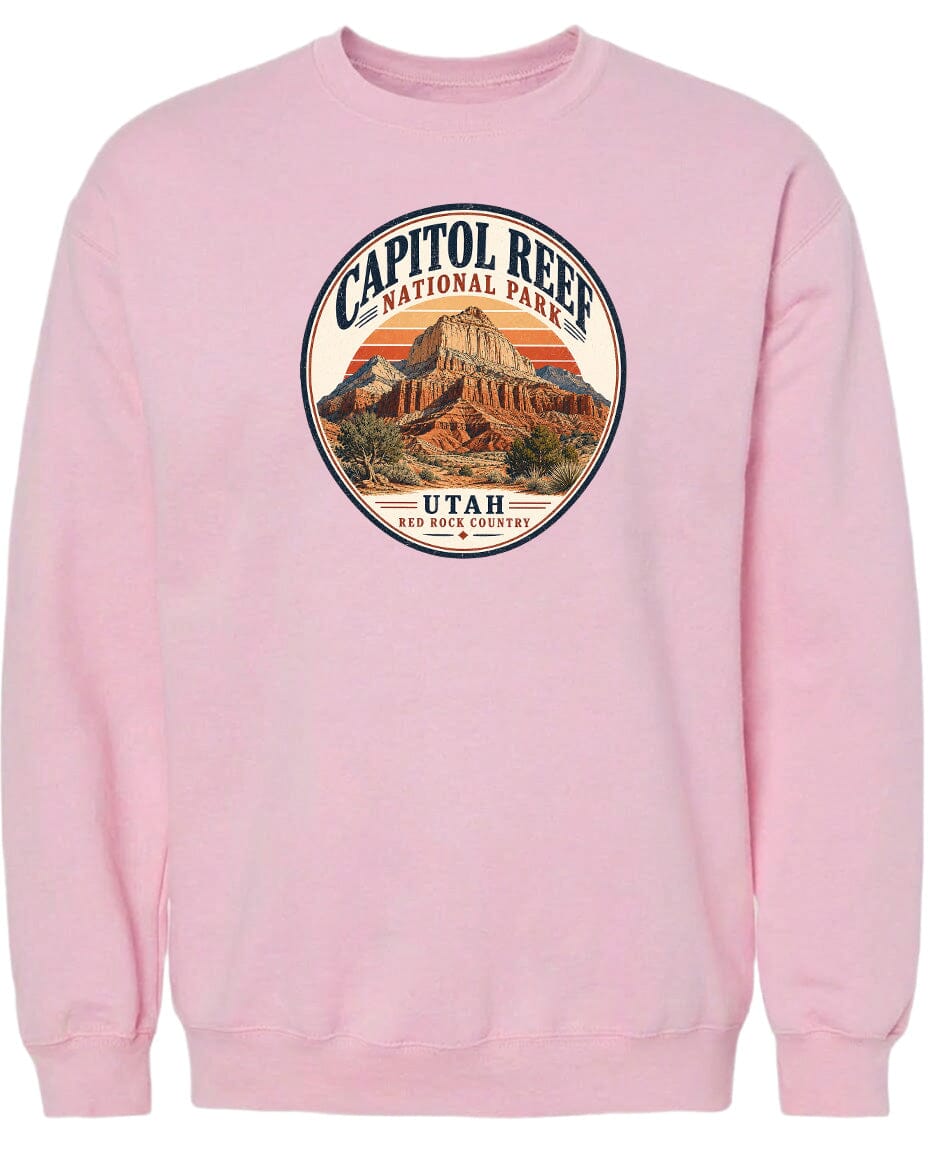 A pink sweatshirt with a circular graphic design featuring the Capitol Reef National Park in Utah.