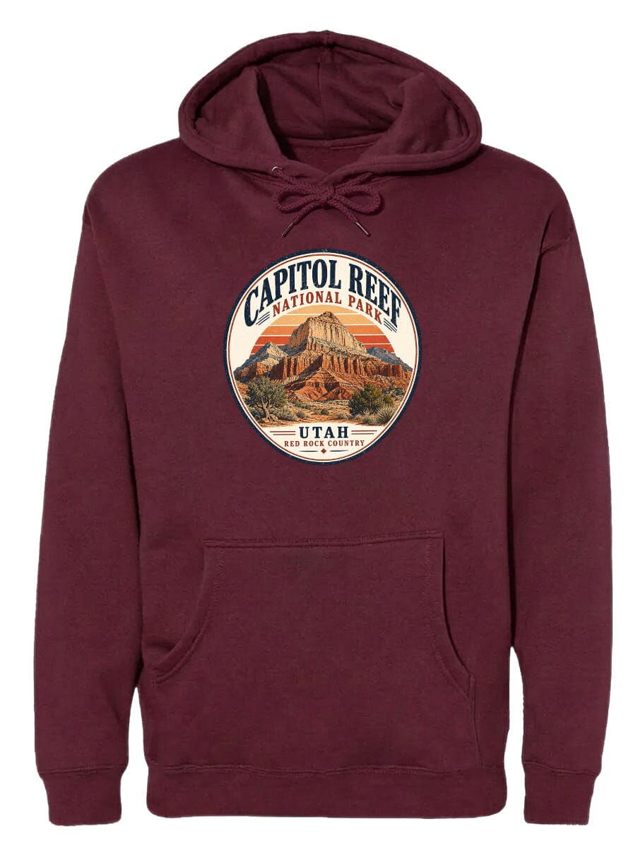 A burgundy-colored hoodie with a circular design featuring the Capitol Reef National Park and Utah, which is a famous landmark in the United States.