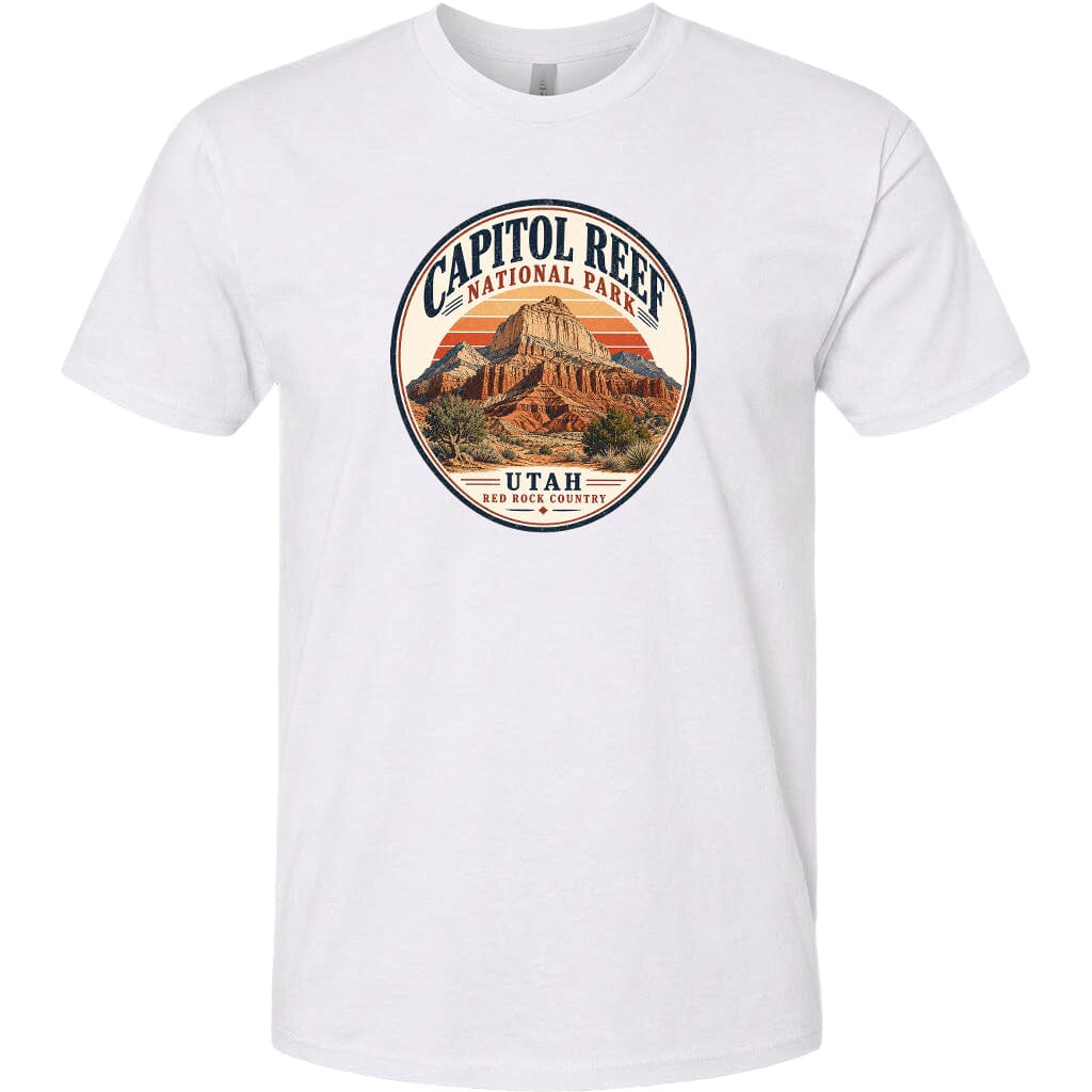 A white t-shirt with a circular design featuring the Capitol Reef National Park in Utah, surrounded by a sunset and desert landscape.