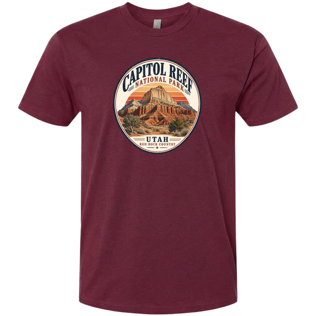 A t-shirt with a circular design featuring the Capitol Reef National Park in Utah, with a mountain and sunset in the background.