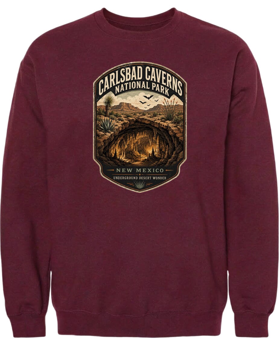 A burgundy-colored sweatshirt with a graphic design depicting the Carlsbad Caverns National Park in New Mexico.