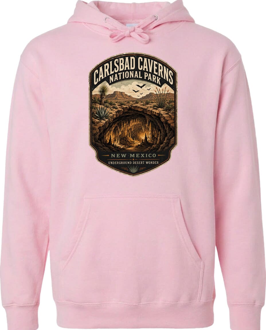 A pink hoodie with a graphic design depicting the Carlsbad Caverns National Park in New Mexico, featuring a desert landscape with a cave and birds in flight.