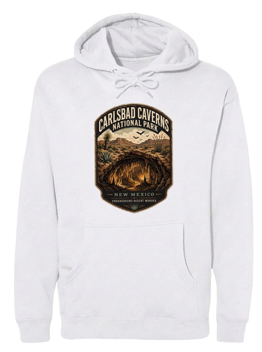 A white hoodie with a graphic design depicting the Carlsbad Caves National Park in New Mexico, featuring a desert landscape with a cave and birds in the background.