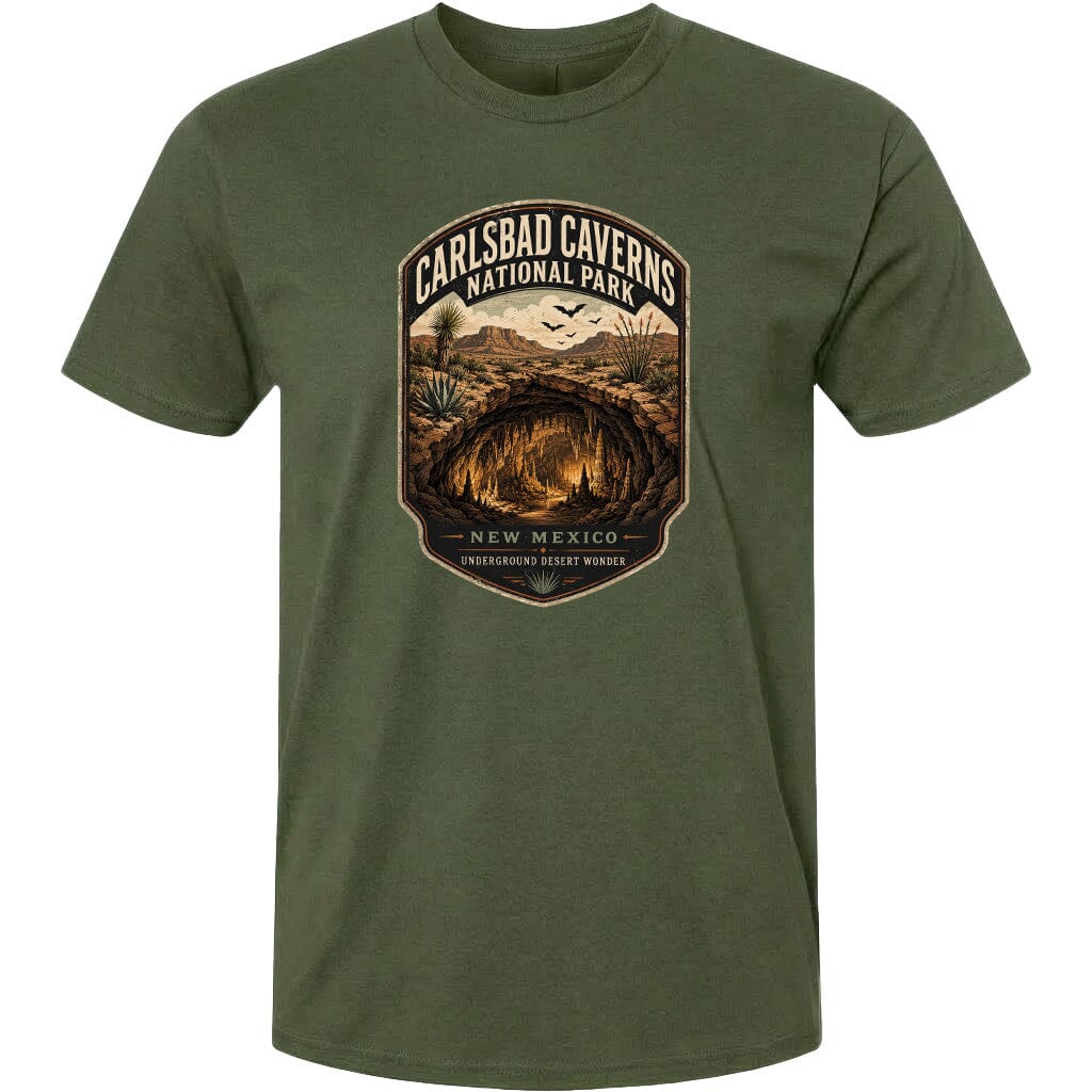 A green t-shirt with a graphic design depicting the Carlsbad Caves National Park in New Mexico, featuring a cave system and desert landscape.