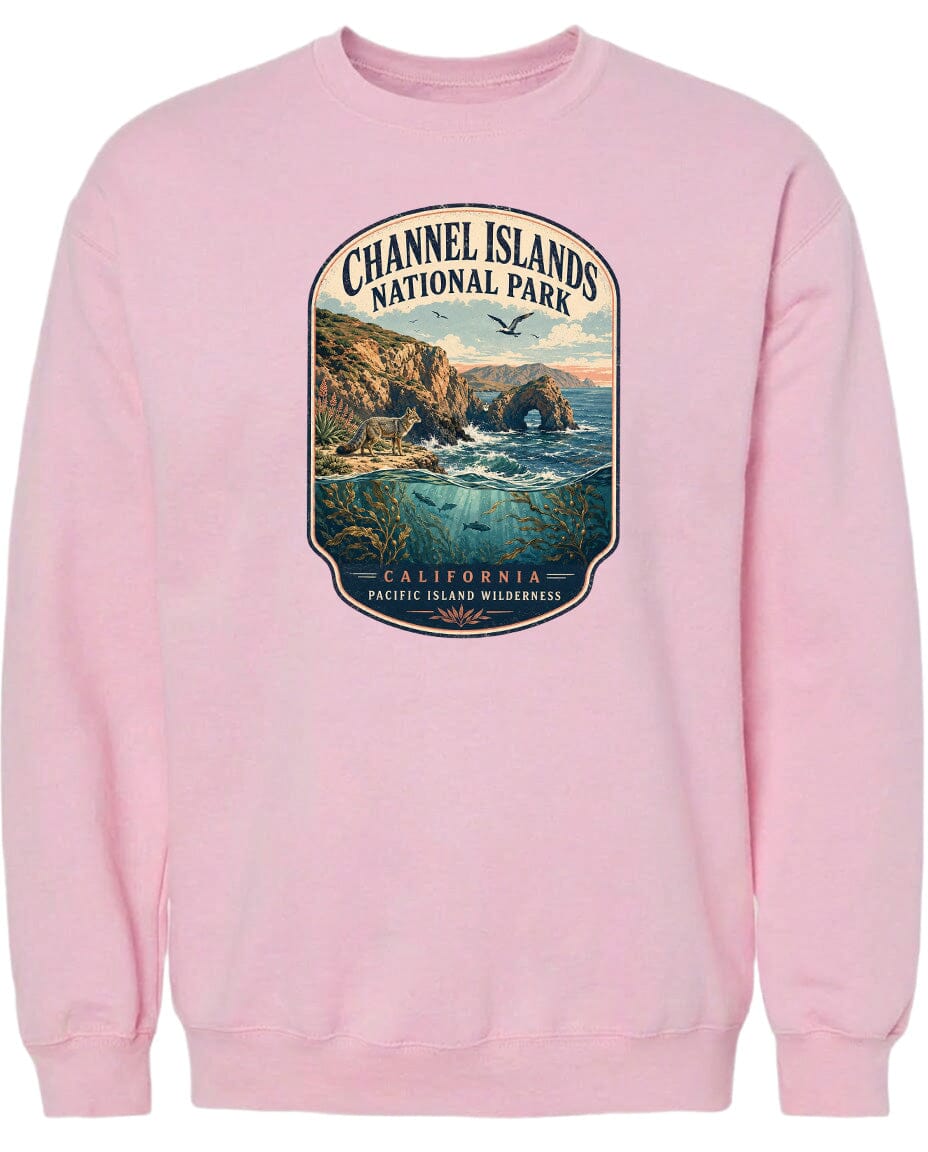 A pink sweatshirt with a graphic design depicting a scenic landscape with cliffs, water, and birds.