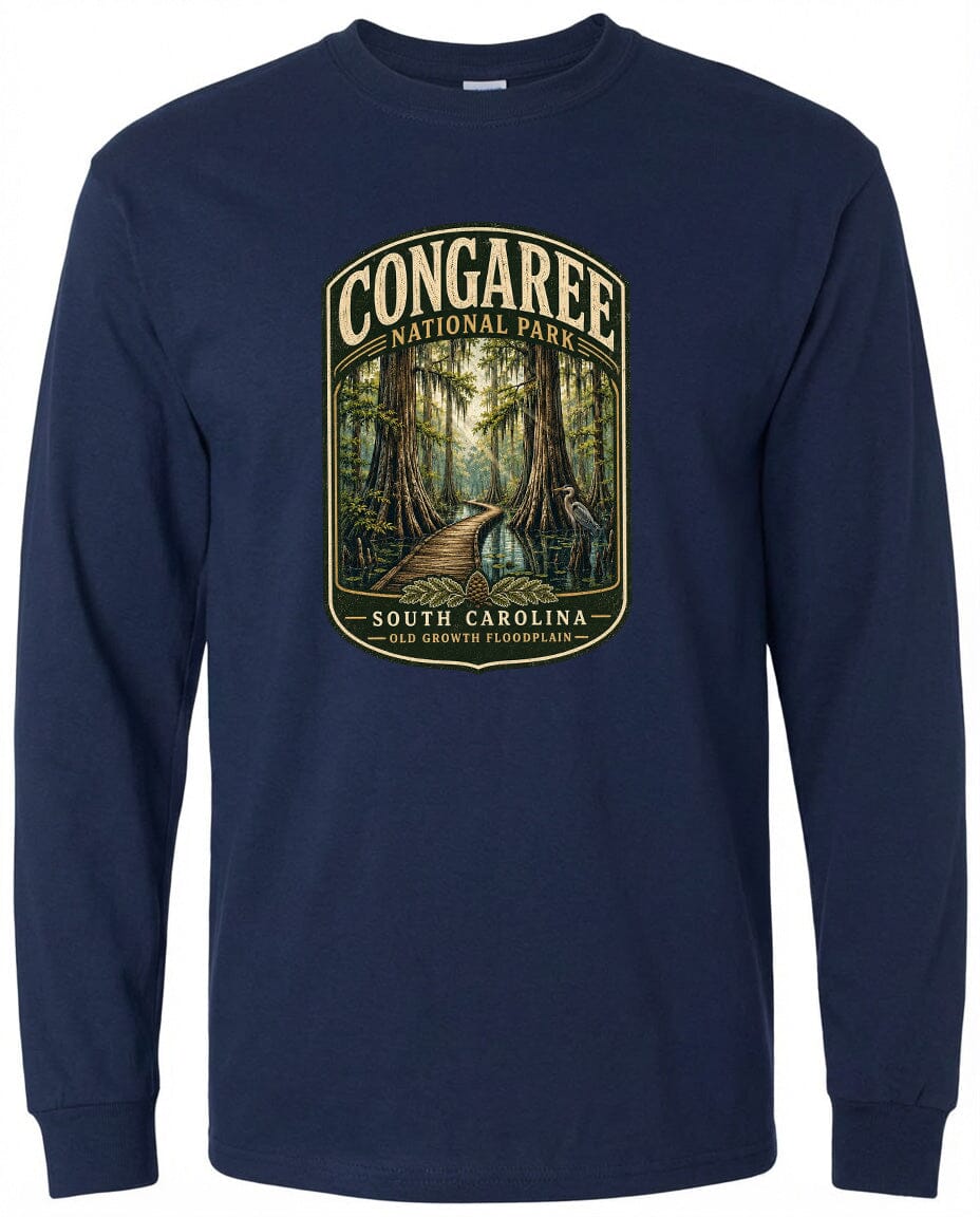 A navy blue long-sleeved t-shirt with a graphic design depicting a forest scene, featuring a path leading through the trees and a bird in the distance.