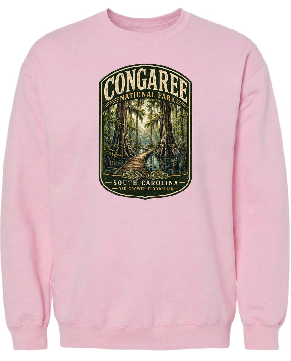 A pink sweatshirt with a graphic design depicting a forest scene with a path leading through it.