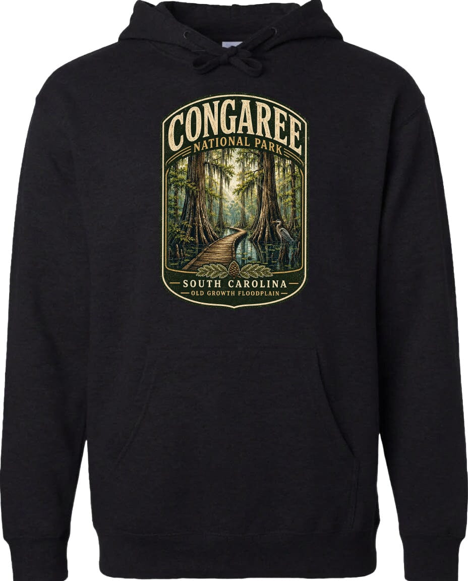 A black hoodie with a graphic design depicting a forest scene with a path leading through it, surrounded by trees and foliage.