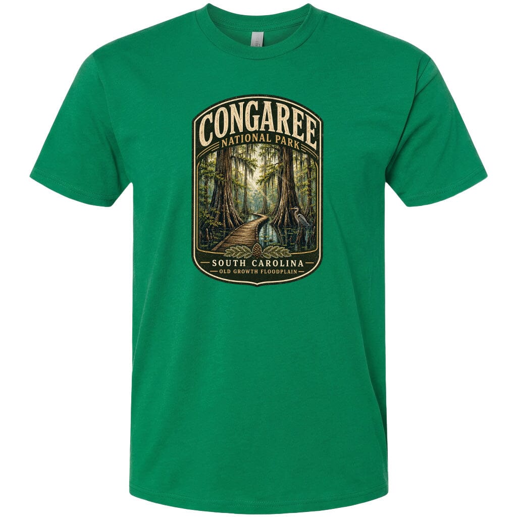 A green t-shirt with a graphic design depicting a forest scene with a path leading through it, surrounded by trees and foliage.