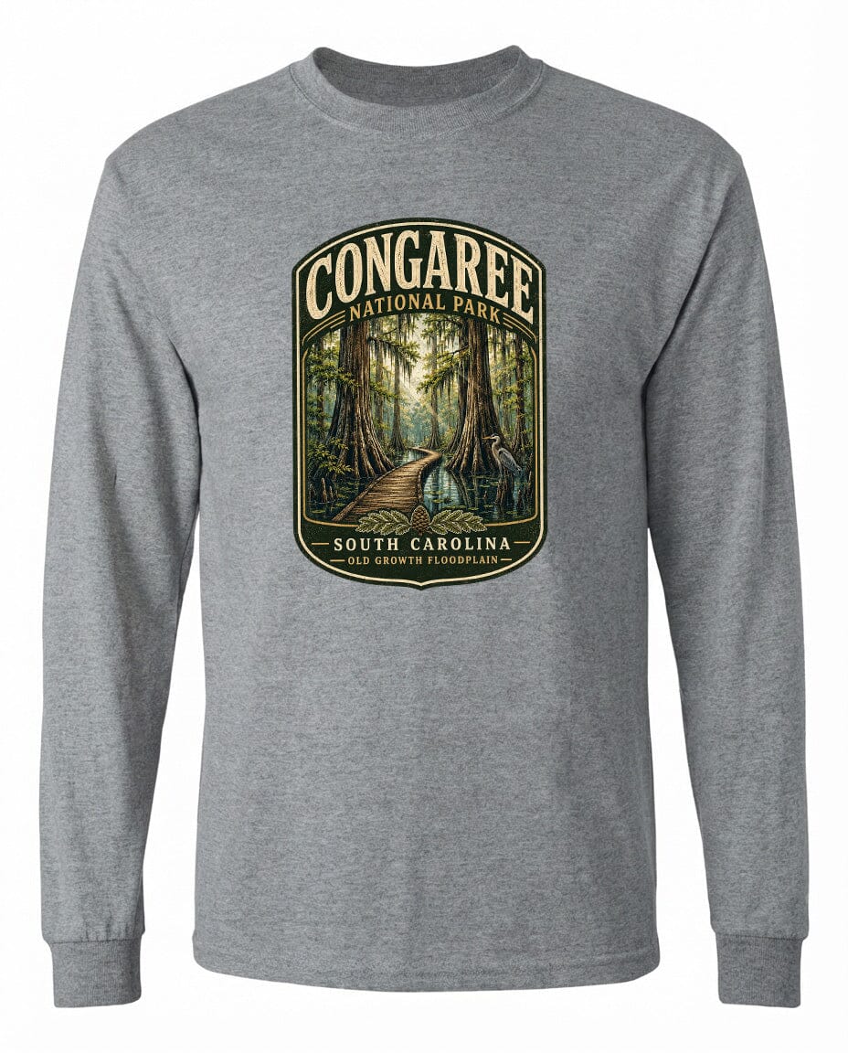 A gray long-sleeved t-shirt with a graphic design depicting a forest path leading through Congaree National Park in South Carolina.