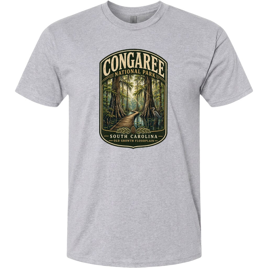 A gray t-shirt with a graphic design depicting a forest scene with a path leading through it, surrounded by trees and foliage.