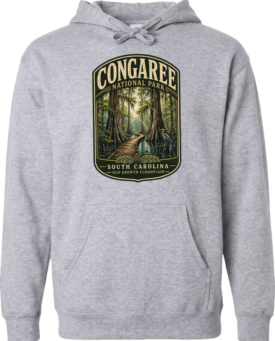 A gray hoodie with a graphic design depicting a forest scene, including a path leading through the trees and a bird in flight.