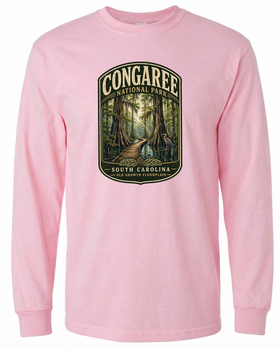 A pink long-sleeved t-shirt with a graphic design depicting a forest scene, featuring a path leading through the trees.
