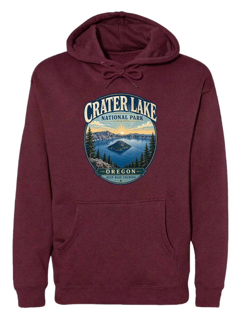 A burgundy hoodie with a graphic design depicting Crater Lake National Park in Oregon, featuring a scenic landscape with a lake, mountains, and forests.