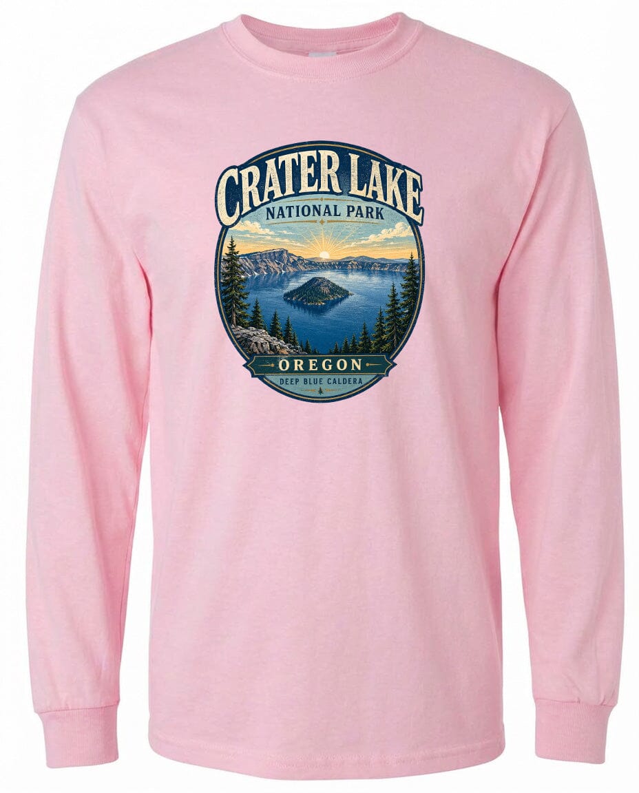 A pink long-sleeved t-shirt with a graphic design depicting Crater Lake National Park in Oregon.