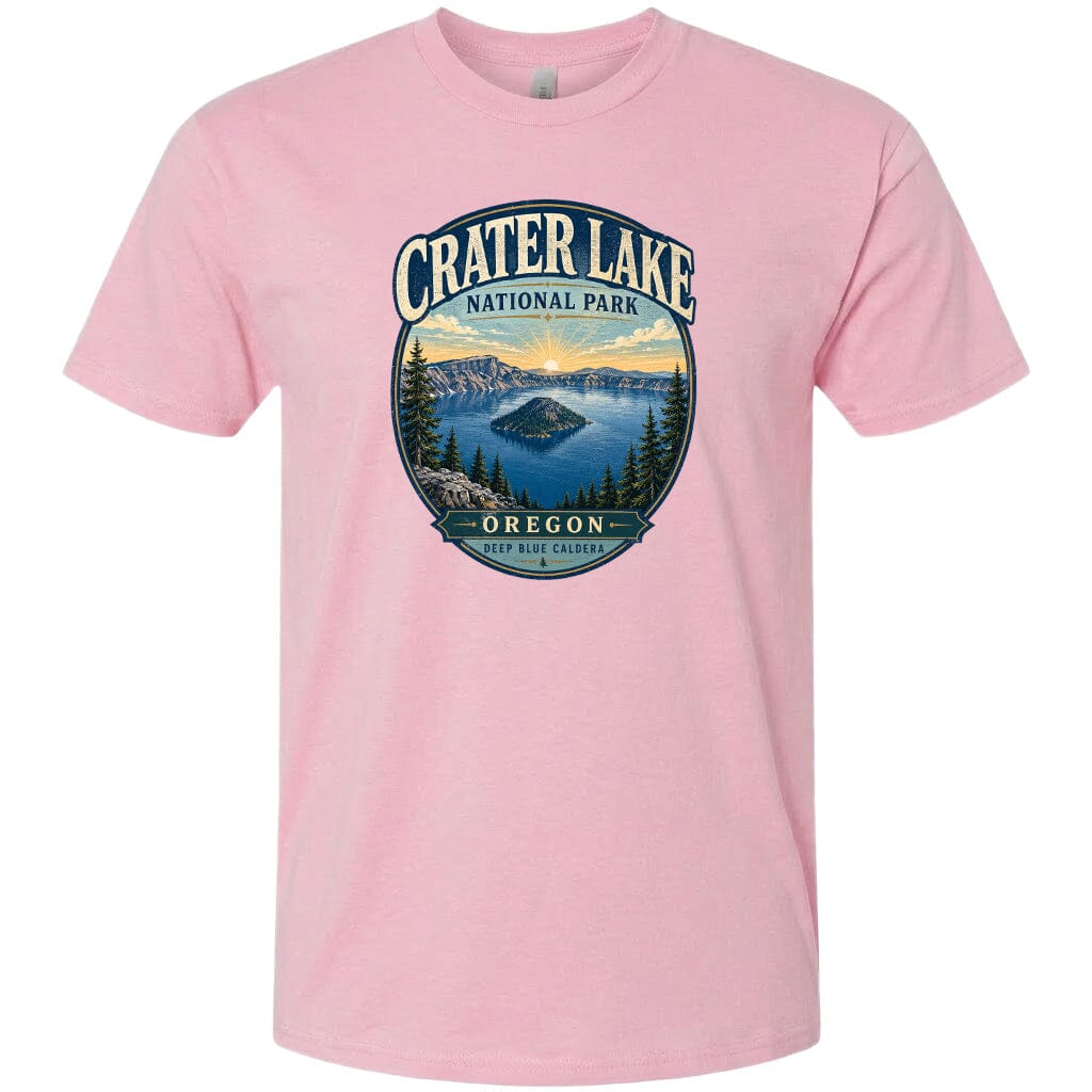 A pink t-shirt with a graphic design depicting Crater Lake National Park in Oregon.