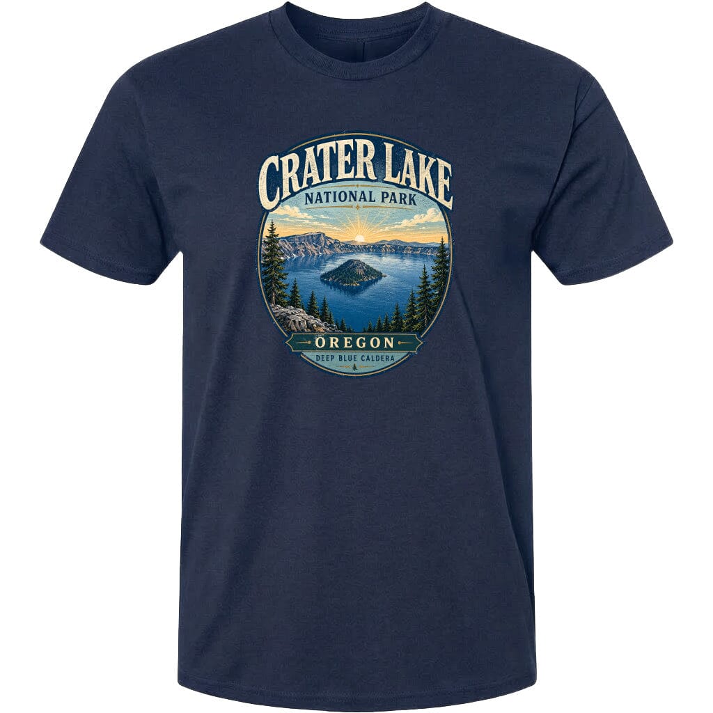 A navy blue t-shirt with a graphic design depicting Crater Lake National Park in Oregon, featuring a scenic landscape with a lake, mountains, and pine trees.
