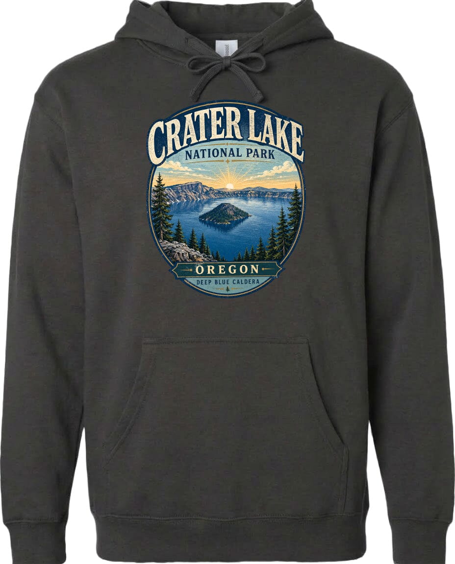 A hoodie with a graphic design featuring a scenic landscape with a lake, mountains, and trees, along with the text "Crater Lake National Park, Oregon" and "Keep Blue Caldera".