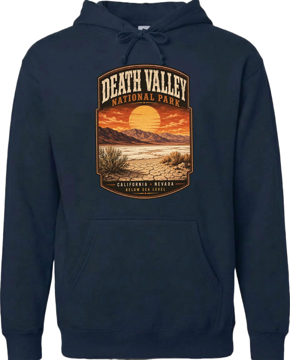 A hoodie with a graphic design depicting a desert landscape with mountains, a sunset, and a cactus plant.