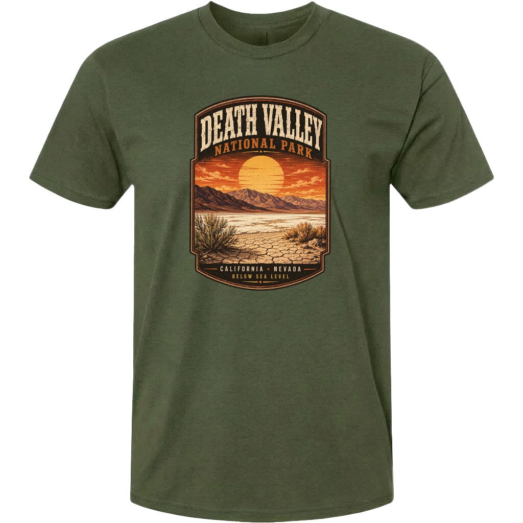 A t-shirt with a graphic design depicting a desert landscape with mountains, a sunset, and a desert plant.