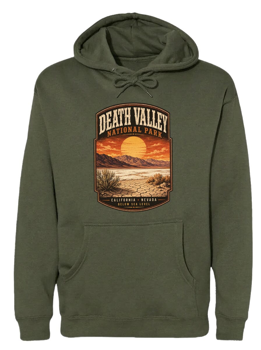 A green hoodie with a graphic design depicting Death Valley National Park, including a sunset landscape and mountains.