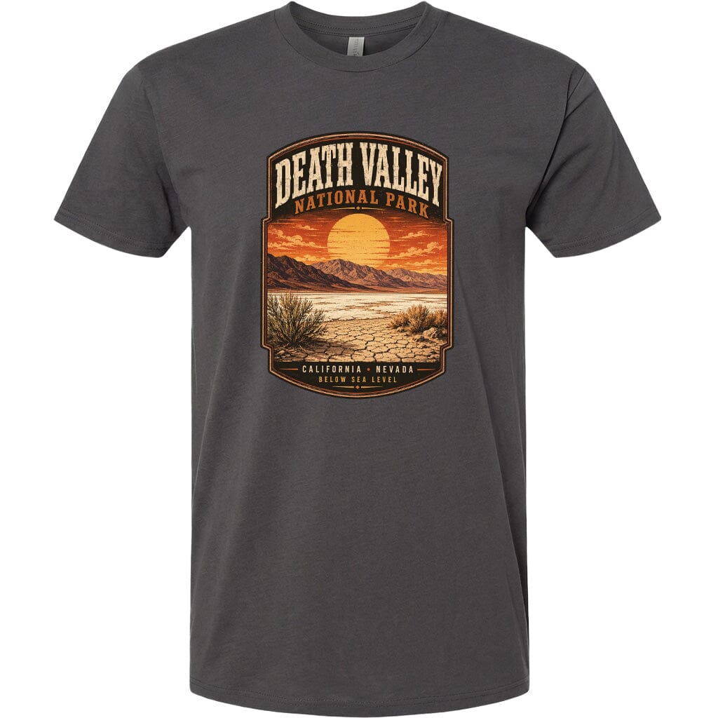 A graphic t-shirt design featuring a desert landscape with mountains, a sunset, and the text "DEATH VALLEY NATIONAL PARK CALIFORNIA NEVADA BELOW SEA LEVEL".