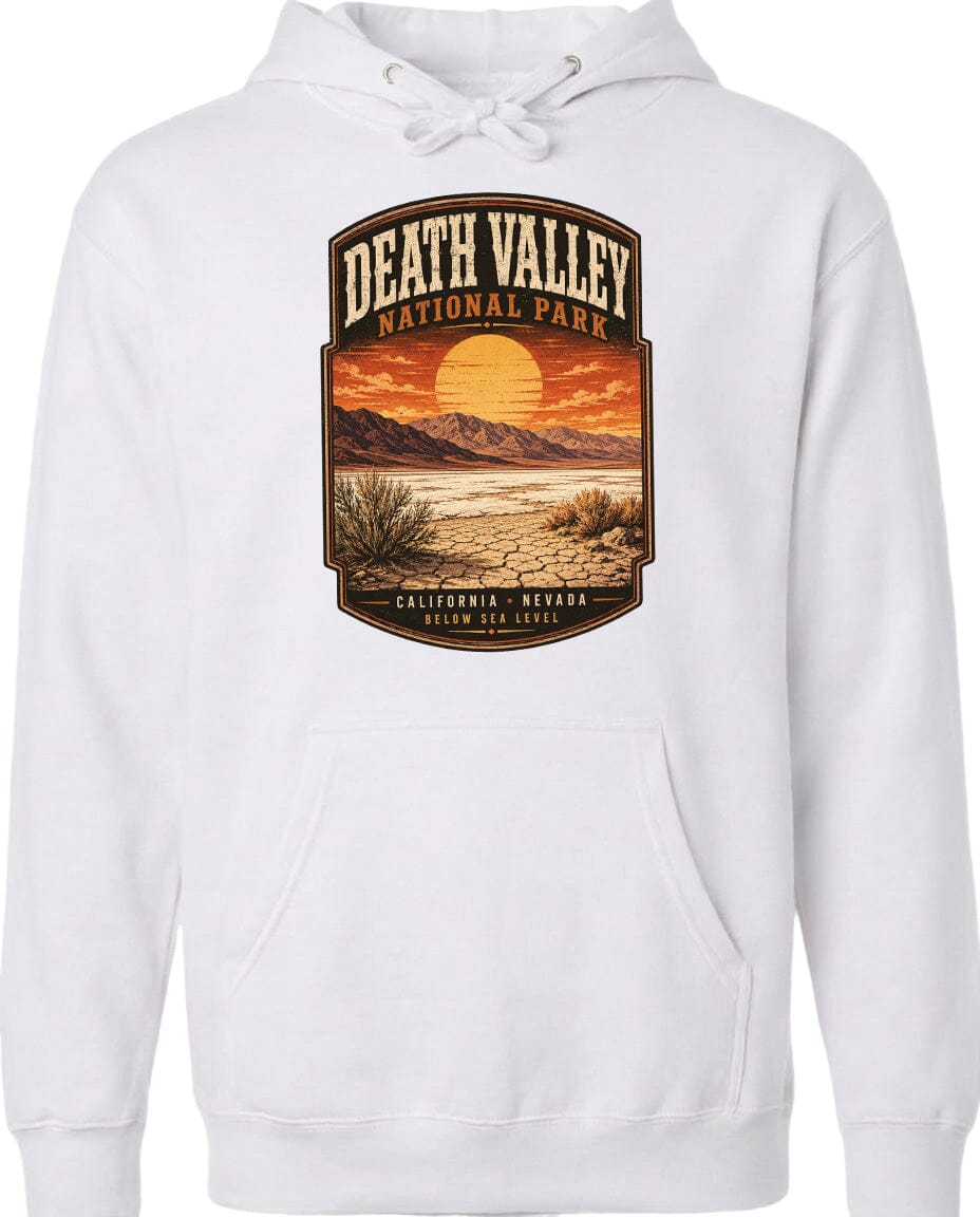A white hoodie with a graphic design depicting a desert landscape with mountains, a sunset, and a cactus plant.