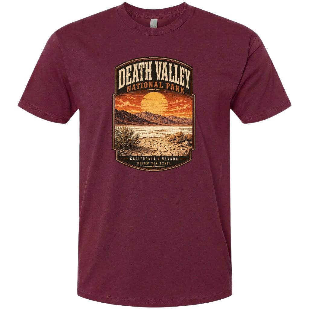 A t-shirt design featuring a desert landscape with mountains, a sunset, and a label that reads "DEATH VALLEY NATIONAL PARK CALIFORNIA - NEVADA BELOW SEA LEVEL".