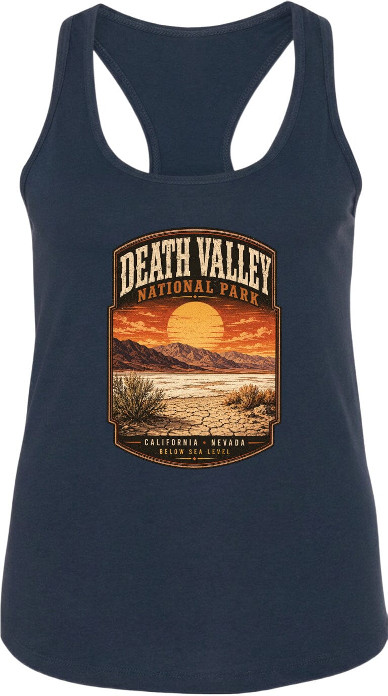 A graphic design on a dark tank top depicting a scenic landscape with mountains, a sunset, and desert vegetation.
