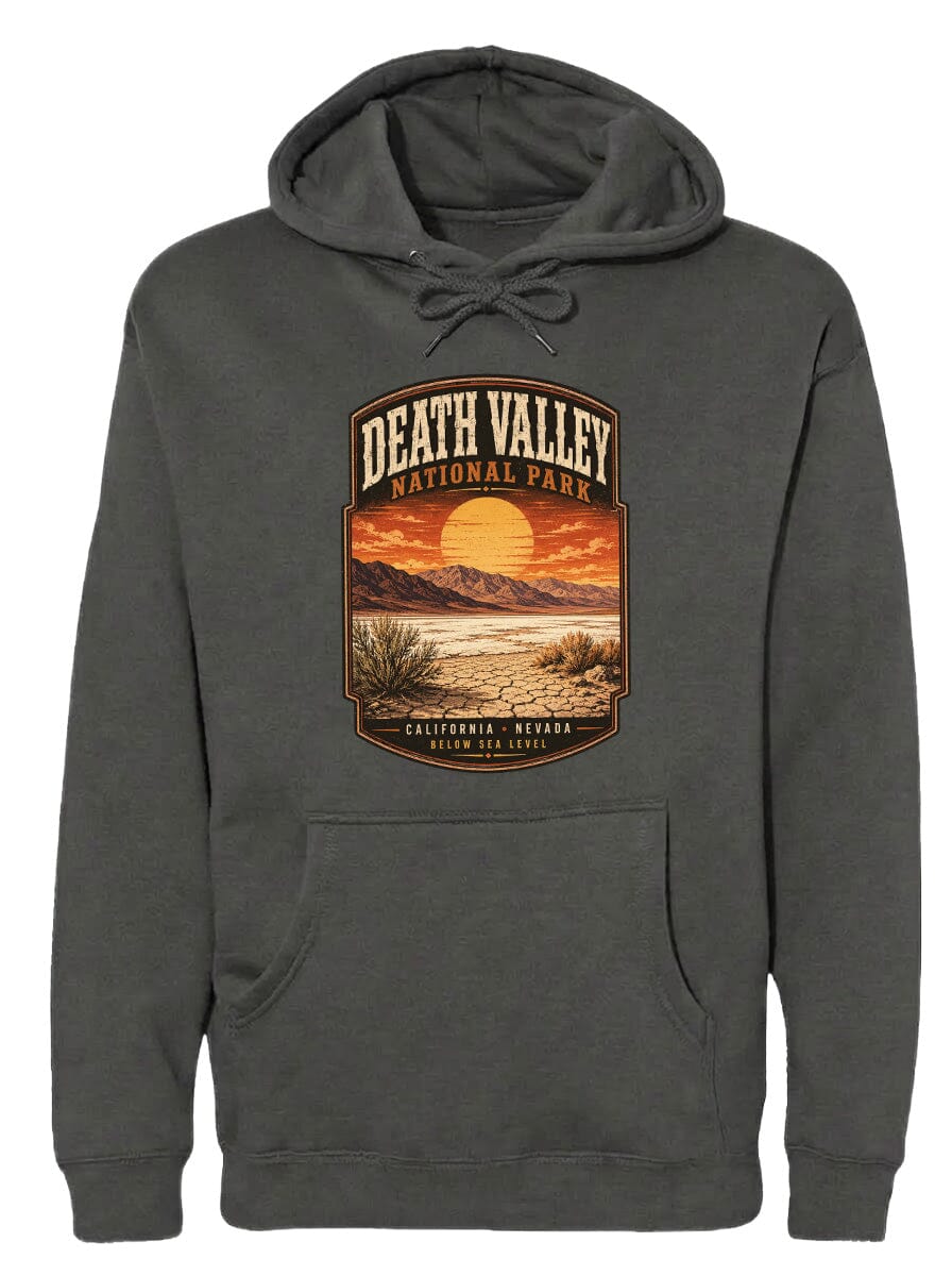 A gray hoodie with a graphic design depicting Death Valley National Park, including a sunset landscape and mountains.
