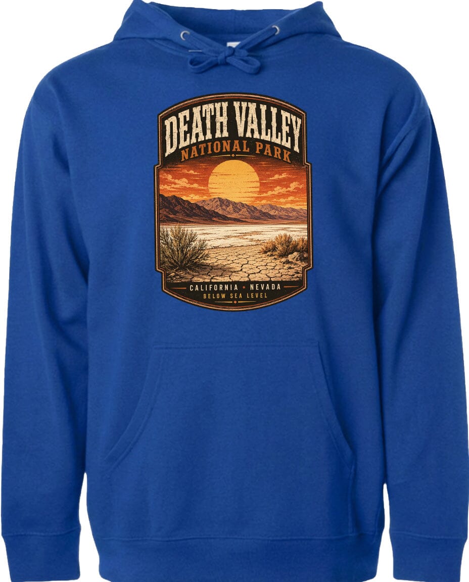 A blue hoodie with a graphic design depicting a desert landscape with mountains, a sunset, and a cactus plant.