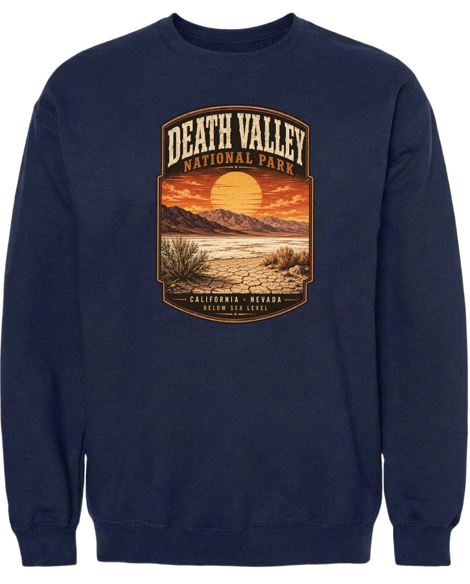 A navy blue sweatshirt with a graphic design depicting a desert landscape with mountains, a sunset, and a cactus.